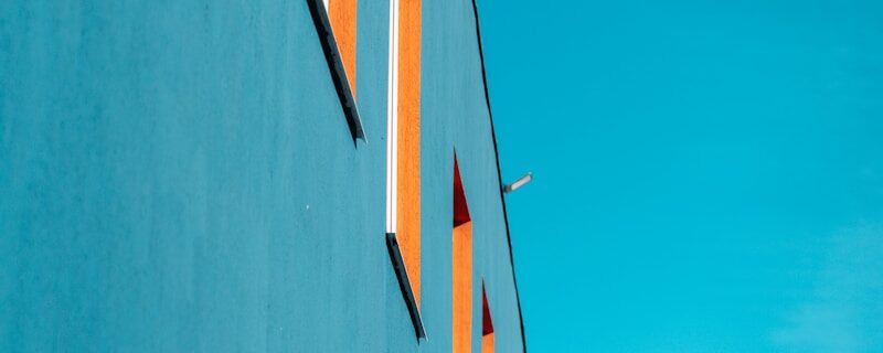 Blue building with orange window frames.