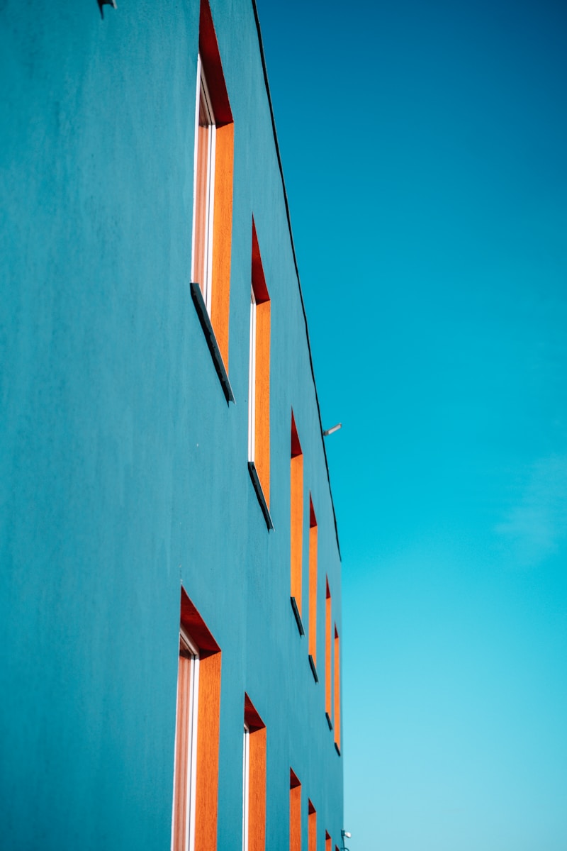 Blue building with orange window frames.